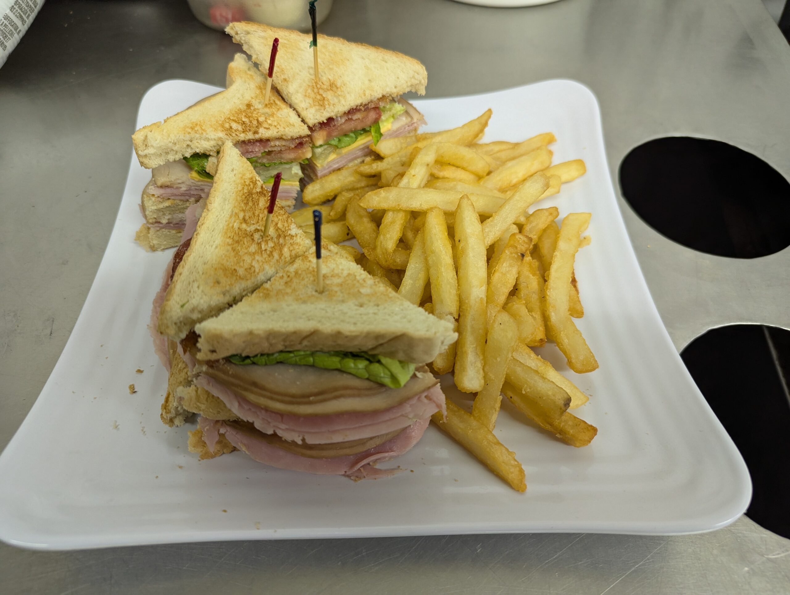 The Banque club sandwich and fries